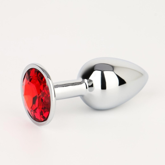 Серебристая анальная втулочка с красным кристаллом - 7 см. Серебристая анальная втулочка с красным кристаллом - 7 см.